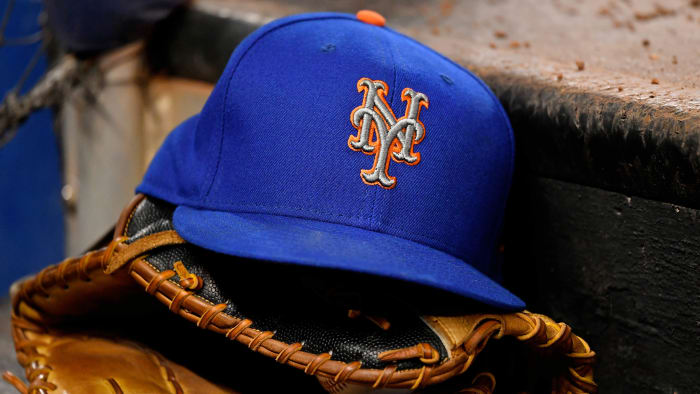 Mets hat sitting on top of glove